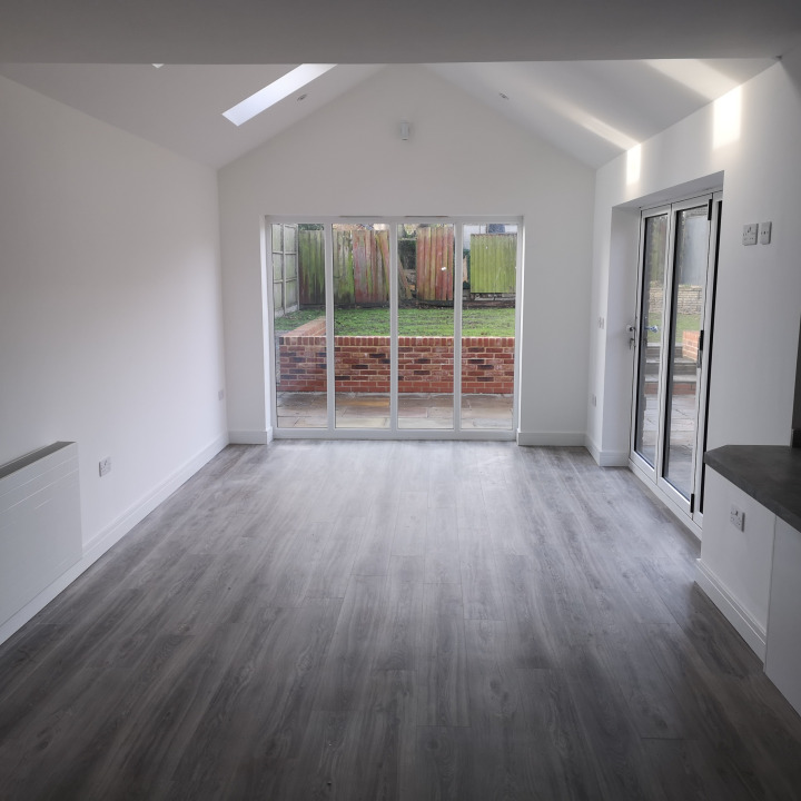 Renovated open plan living with large window and bifold doors